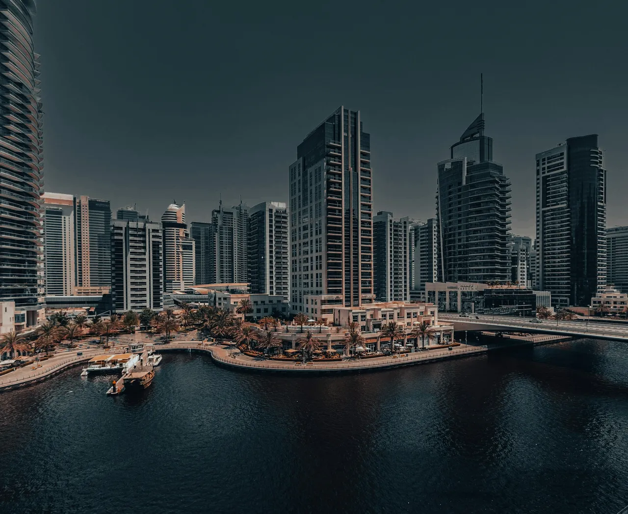 Dubai Marina waterfront and bridge beside completed residential towers